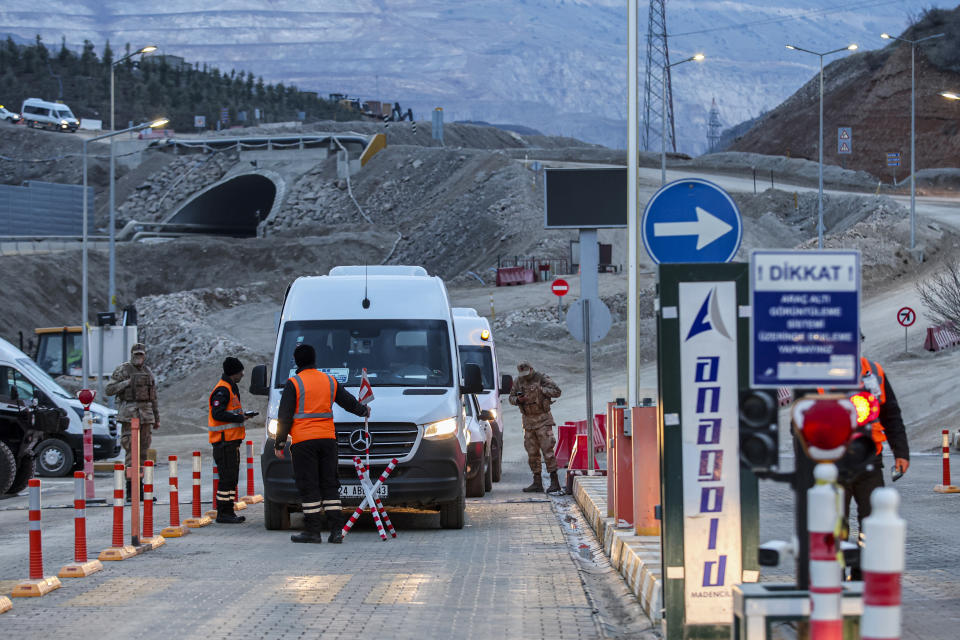 Security personnel stand at the entrance of the Copler gold mine near Ilic village, eastern Turkey, Wednesday, Feb. 14, 2024. Hundreds of rescuers on Wednesday pressed ahead with efforts to search for several workers trapped at a gold mine in eastern Turkey that was engulfed by a massive landslide. (Ugur Yildirim/Dia images via AP)