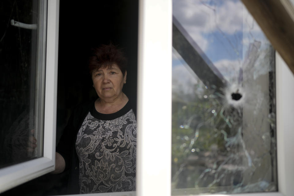 Nataliia Fedorova poses for a picture at her home ruined by attacks in Irpin, on the outskirts of Kyiv, Ukraine, Thursday, May 26, 2022. (AP Photo/Natacha Pisarenko)