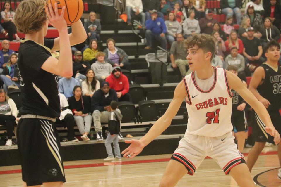 North Rock Creek's Jordan Coody (21) guards Latta's Konner Turner during action Tuesday night at North Rock Creek.