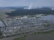 CAPTION CORRECTS LOCATION - Houses are seen underwater in the flooded village of Dnipryany, in Russian-occupied Ukraine, Wednesday, June 7, 2023, after the collapse of Kakhovka Dam. (AP Photo)