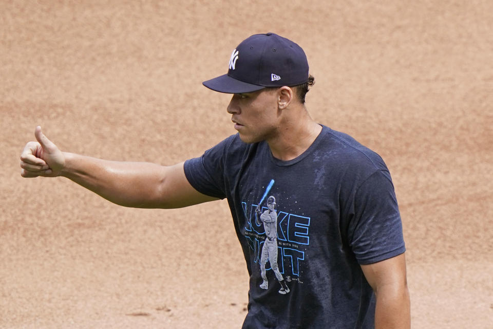 New York Yankees right fielder Aaron Judge, who is on the injured list, gives a thumbs up to the Yankees bench coach after fielding a few balls in the outfield before the start of a baseball game, Sunday, Sept. 13, 2020, at Yankee Stadium in New York. (AP Photo/Kathy Willens)