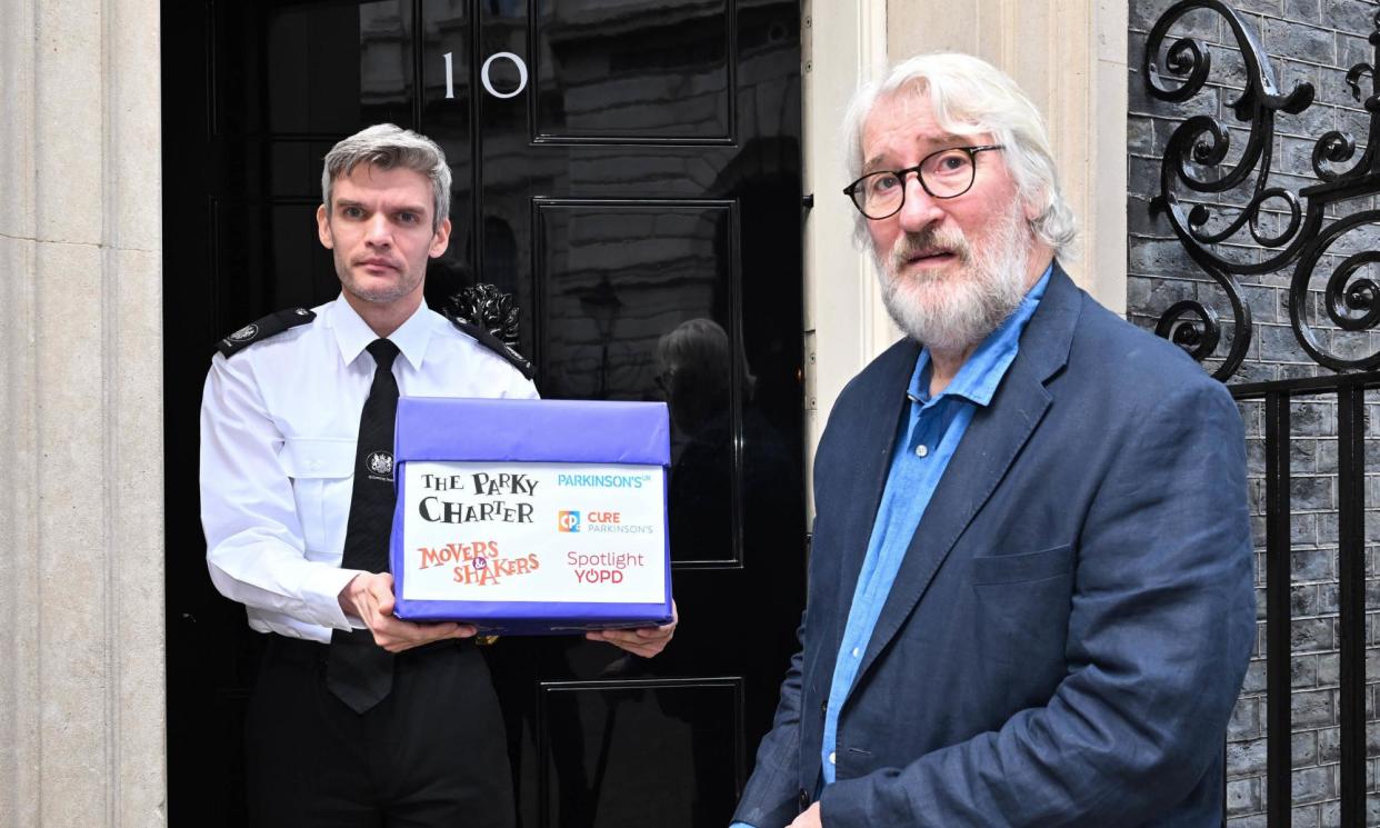<span>Jeremy Paxman handing in the Parky Charter petition at No 10. It covers five key areas of concern around the condition.</span><span>Photograph: Matt Crossick/PA Media Assignments/PA</span>