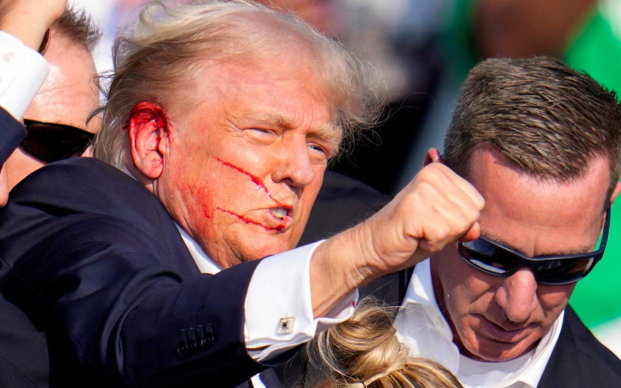 Former president Donald Trump raises his fist following an attempt on his life at a campaign event in Pennsylvania