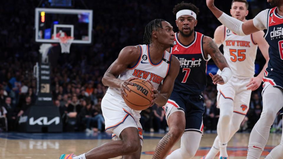 Apr 2, 2023; New York, New York, USA; New York Knicks guard Immanuel Quickley (5) moves toward the basket as Washington Wizards forward Taj Gibson (67) and guard Jordan Goodwin (7) defend during the first quarter at Madison Square Garden. Mandatory Credit: Vincent Carchietta-USA TODAY Sports