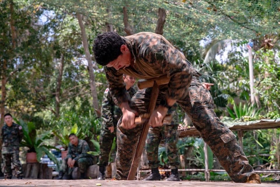 A US Navy special operations independent duty corpsman attempts to make a fire from bamboo