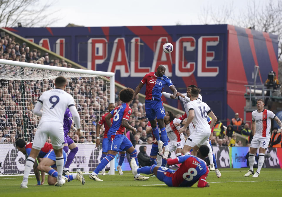 Crystal Palace's Jean-Philippe Mateta, centre, clears the ball, during the English Premier League soccer match between Crystal Palace and Luton Town, at Selhurst Park, in London, Saturday March 9, 2024. (Bradley Collyer/PA via AP)