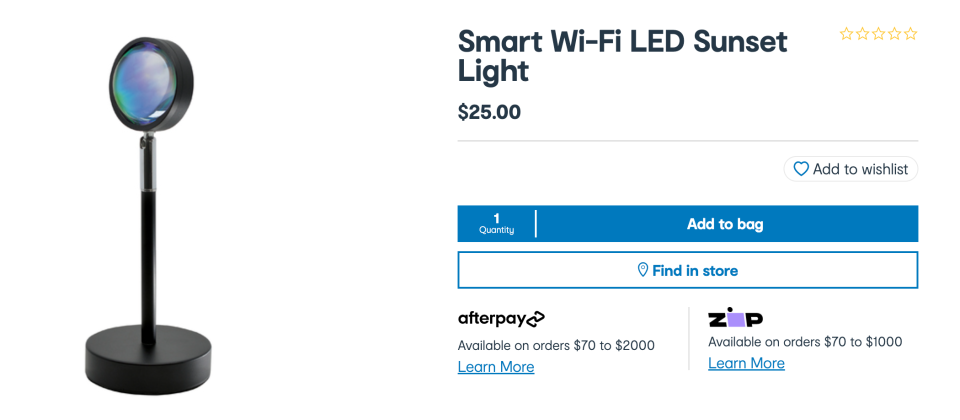 The new smart Sunset Lamp from  Kmart is pictured on its black base and stand next to its online store listing.