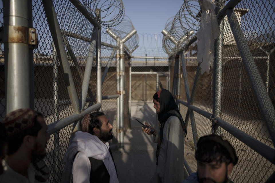 Taliban fighters enter an area where they are holding inmates who have been recently arrested at the Pul-e-Charkhi prison in Kabul, Afghanistan, Monday, Sept. 13, 2021. Pul-e-Charkhi was previously the main government prison for holding captured Taliban and was long notorious for abuses, poor conditions and severe overcrowding with thousands of prisoners. Now after their takeover of the country, the Taliban control it and are getting it back up and running, current holding around 60 people, mainly drug addicts and accused criminals. (AP Photo/Felipe Dana)