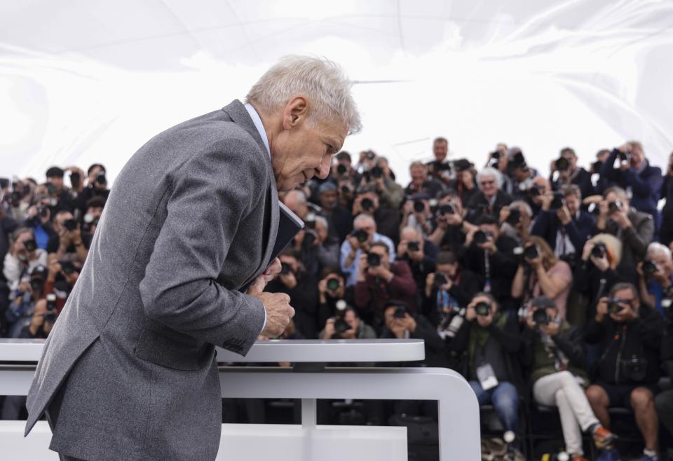 Harrison Ford poses for photographers with his honorary Palme d'Or at the photo call for the film ???Indiana Jones and the Dial of Destiny??? at the 76th international film festival, Cannes, southern France, Friday, May 19, 2023. (Photo by Vianney Le Caer/Invision/AP)