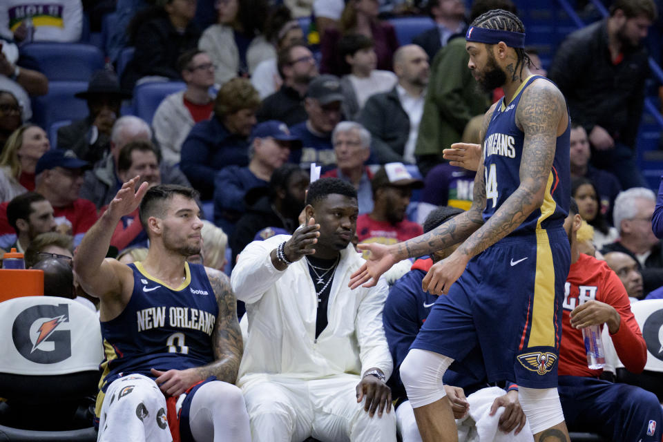 New Orleans Pelicans forward Brandon Ingram (14) slaps hands with forward Zion Williamson, center, and center Willy Hernangomez during the first half of the team's NBA basketball game against the Minnesota Timberwolves in New Orleans, Wednesday, Jan. 25, 2023. (AP Photo/Matthew Hinton)