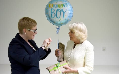 Britain's Camilla, Duchess of Cornwall receives a balloon for her newborn grandchild  - Credit: Ralf Hirschberger/DPA Pool