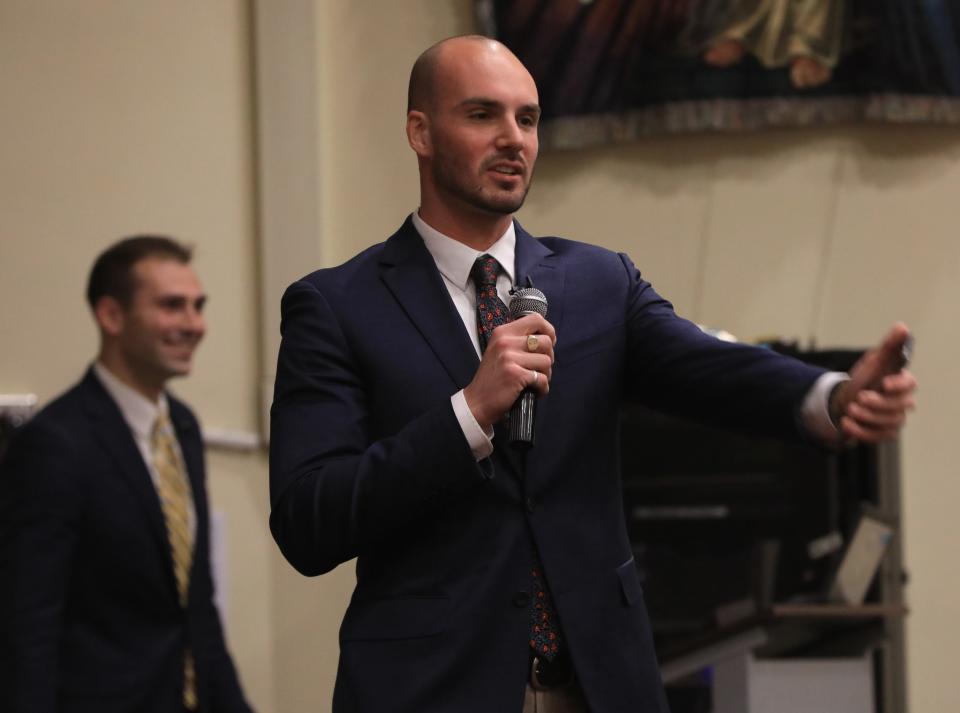 Luke Timm, a 2016 graduate from Our Lady of Lourdes High School, talks about his struggles with drug addiction during an assembly at the high school on May 10, 2023. 