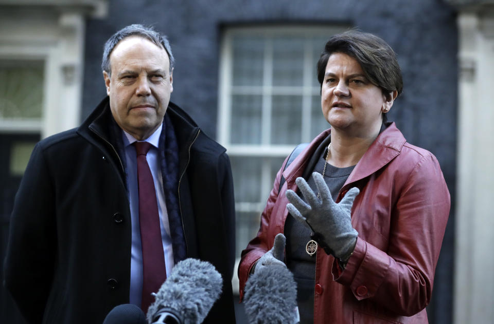 DUP Party leader Arlene Foster and Deputy Leader Nigel Dodds, left, make a statement to the media after exiting 10 Downing Street. London, Thursday Jan. 17, 2019. British Prime Minister Theresa May is reaching out to opposition parties and other lawmakers Thursday in a battle to put Brexit back on track after surviving a no-confidence vote. (AP Photo/Matt Dunham)