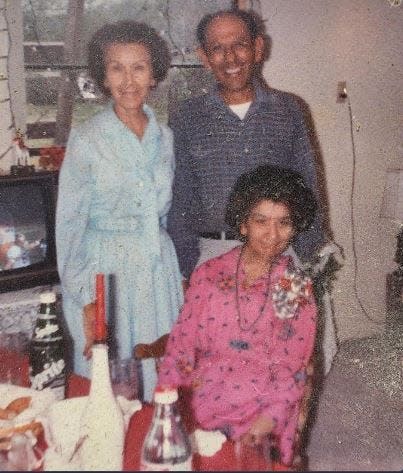 Escolastica Harrison, Robert Harrison and Bella Cuellar pictured at a Thanksgiving dinner in November 1988.