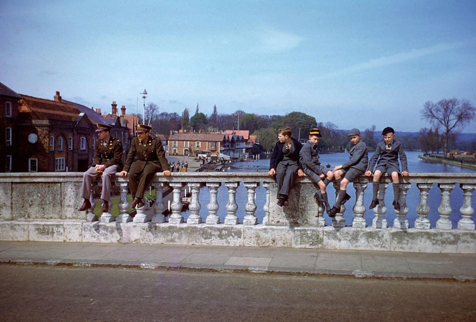 Troops and civilians pass the time on the River Thames in the spring of 1944.