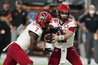 North Carolina State quarterback Devin Leary (13) hands off to running back Zonovan Knight (7) during the first half of the team's NCAA college football game against Miami, Saturday, Oct. 23, 2021, in Miami Gardens, Fla. (AP Photo/Wilfredo Lee)