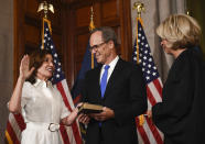New York Chief Judge Janet DiFiore swears in Kathy Hochul as the first woman to be New York's governor while her husband Bill Hochul holds a bible during a ceremonial swearing-in ceremony at the state Capitol, Tuesday, Aug. 24, 2021, in Albany, N.Y. (AP Photo/Hans Pennink, Pool)