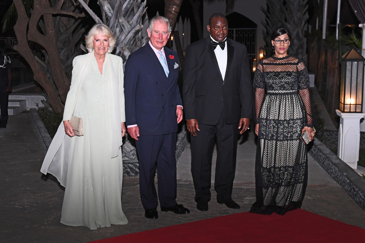 The Prince of Wales and Duchess of Cornwall with President Adama Barrow and his wife arrive at the state dinner (PA)