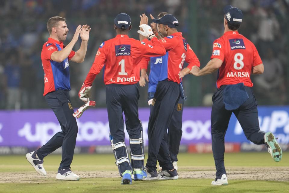 Delhi Capitals Anrich Nortje, left, celebrates wicket of Gujarat Titans' Shubman Gill with his team players during the Indian Premier League (IPL) cricket match between Delhi Capitals and Gujarat Titans in New Delhi, India, Tuesday, April 4, 2023. (AP Photo/Manish Swarup)