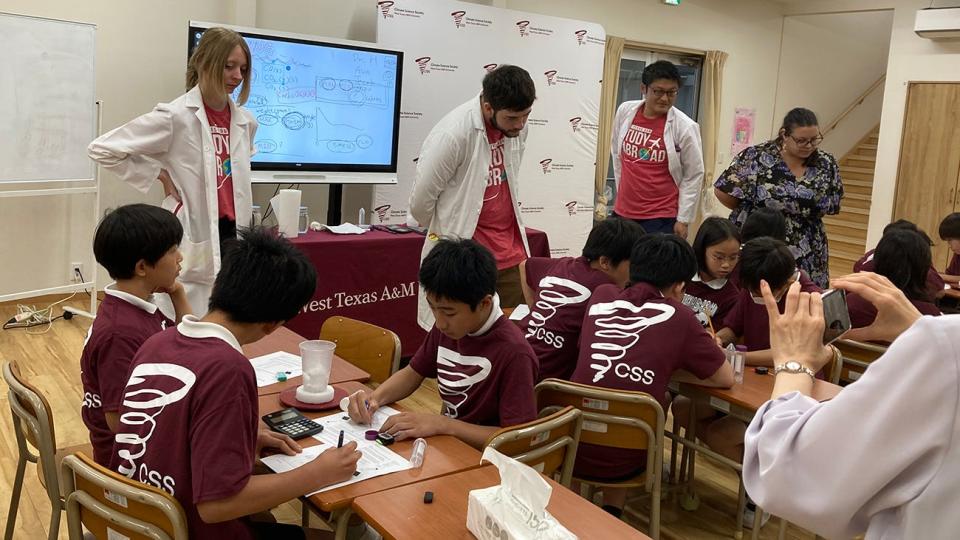 WT students Ava Sealy and Jacob Hurst, both standing center, and Dr. Naruki Hiranuma, associate professor of environmental science, traveled to several schools in Japan over the summer to teach climate science.