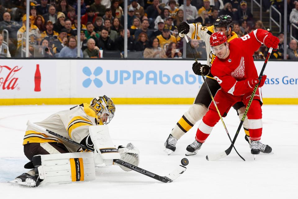 Red Wings right wing Alex DeBrincat goes for a rebound in front of Bruins goaltender Jeremy Swayman during the second period on Friday, Nov. 24, 2023, in Boston.