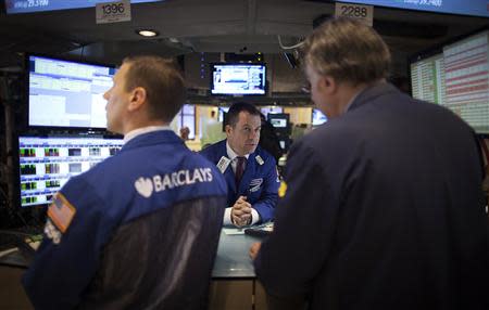 Traders work on the floor of the New York Stock Exchange during the opening bell in New York, November 27, 2013. REUTERS/Carlo Allegri