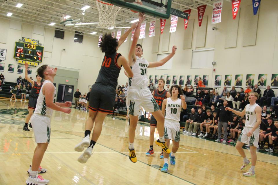 Woodward-Granger's Austin Taylor fights for a rebound against Madrid's Brody Buck on Friday, Dec. 9, 2022, in Woodward.