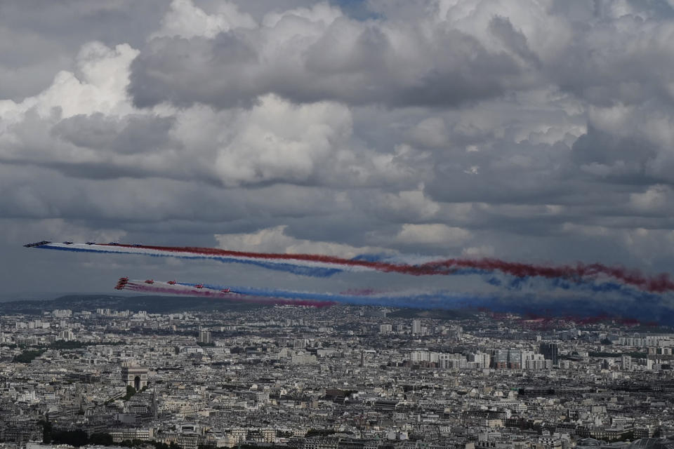 French Alpha jets of the Patrouille de France and the UK Royal red arrows aerobatic planes spraying lines of smoke in the colors of the French flag fly over the Arc de Triomphe, left, in Paris, Thursday, June 18, 2020 as part of commemoration for the 80th anniversary of Charles de Gaulle's radio appeal to his countrymen to resist Nazi occupation during WWII. French President Emmanuel Macron is traveling to London to mark the day that De Gaulle delivered his defiant broadcast 80 years ago urging his nation to fight on despite the fall of France. In a reflection of the importance of the event, the trip marks Macron's first international trip since France's lockdown amid the COVID-19 pandemic. (AP Photo/Francois Mori)