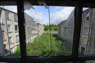 The view through a broken window on the estate (Picture: SWNS)