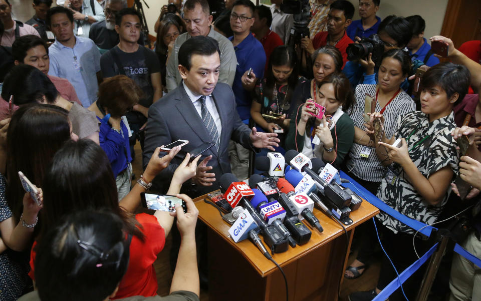 Philippine opposition Sen. Antonio Trillanes IV gestures as he talks to the media outside his office in the Philippine Senate after posting bail at a regional trial court following an arrest warrant issued Tuesday, Sept. 25, 2018 in suburban Pasay city, south of Manila, Philippines. Trillanes IV vowed to remain holed up in his office at the Senate until he is cleared of all the charges against him after President Rodrigo Duterte voided an amnesty given to the former rebel military officer. (AP Photo/Bullit Marquez)