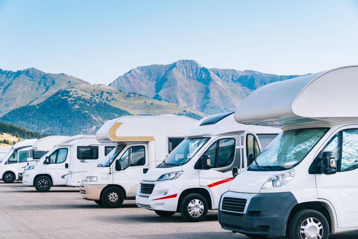 RV parked in a camper parking area. Concept of summer tourism with caravan. Best option for travel in times of coronavirus pandemic.