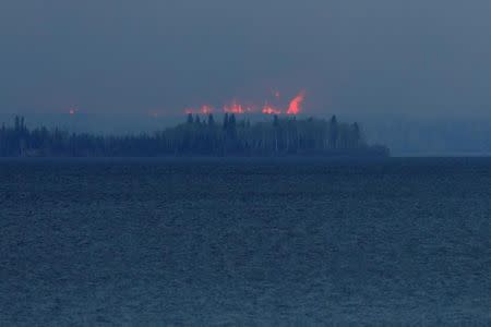 Wildfires burn across Gregoire Lake near Fort McMurray, Alberta, Canada, May 5, 2016. REUTERS/Chris Wattie