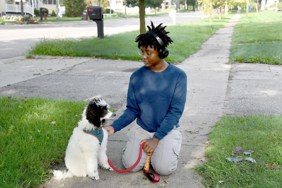 Ny Kershaw, 17, of Carleton is pictured with his service dog, a 16-week-old poodle named Keita, who is in training.