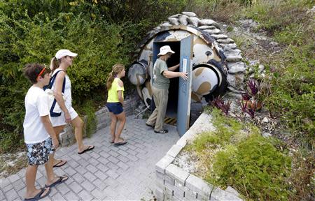 Guests, led by curator Ruth Pelletier (R), enter the cold-war era nuclear fallout shelter constructed for U.S. President John F. Kennedy on Peanut Island near Riviera Beach, Florida November 8, 2013. REUTERS/Joe Skipper