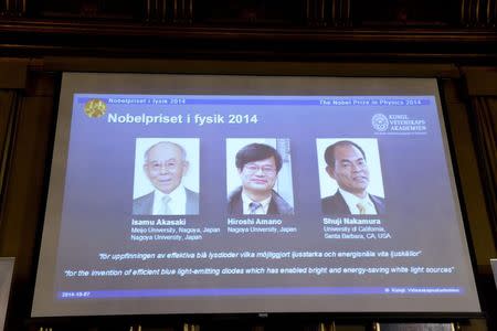 Japanese scientists Isamu Akasaki and Hiroshi Amano, and U.S. scientist Shuji Nakamura (L-R) are seen on a screen after being announced as the 2014 Nobel Physics Laureates at the Royal Swedish Academy of Science in Stockholm, October 7, 2014. REUTERS/Bertil Ericson/TT News Agency