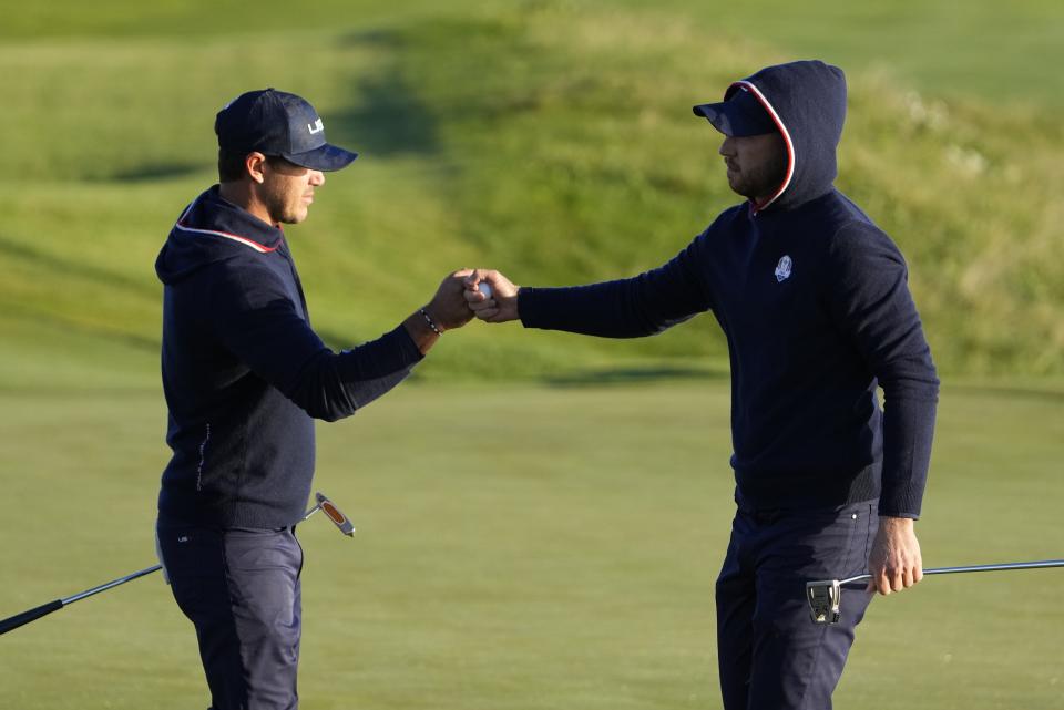 Team USA's Daniel Berger and Team USA's Brooks Koepka react after winning the second hole during a foursomes match the Ryder Cup at the Whistling Straits Golf Course Saturday, Sept. 25, 2021, in Sheboygan, Wis. (AP Photo/Jeff Roberson)