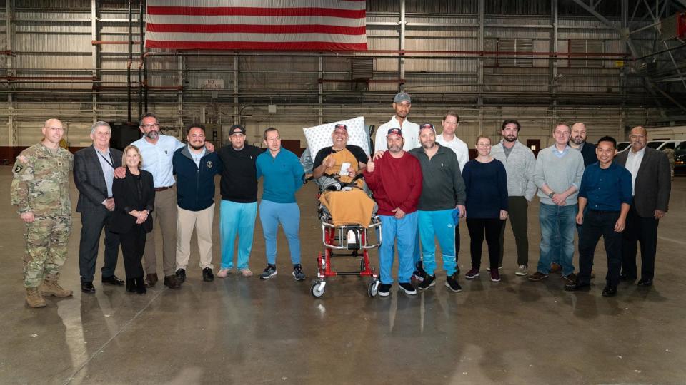 PHOTO: U.S. citizens imprisoned in Venezuela pose for pictures upon arrival at Joint Base San Antonio Kelly Annex in San Antonio, Texas, on Dec. 20, 2023, after being freed amid a prisoner swap deal between the United States and Venezuela.  (Suzanne Cordeiro/AFP via Getty Images)