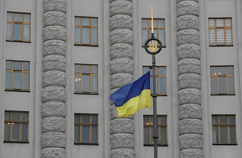 FILE PHOTO: A Ukrainian national flag flies in front of government building in central Kiev