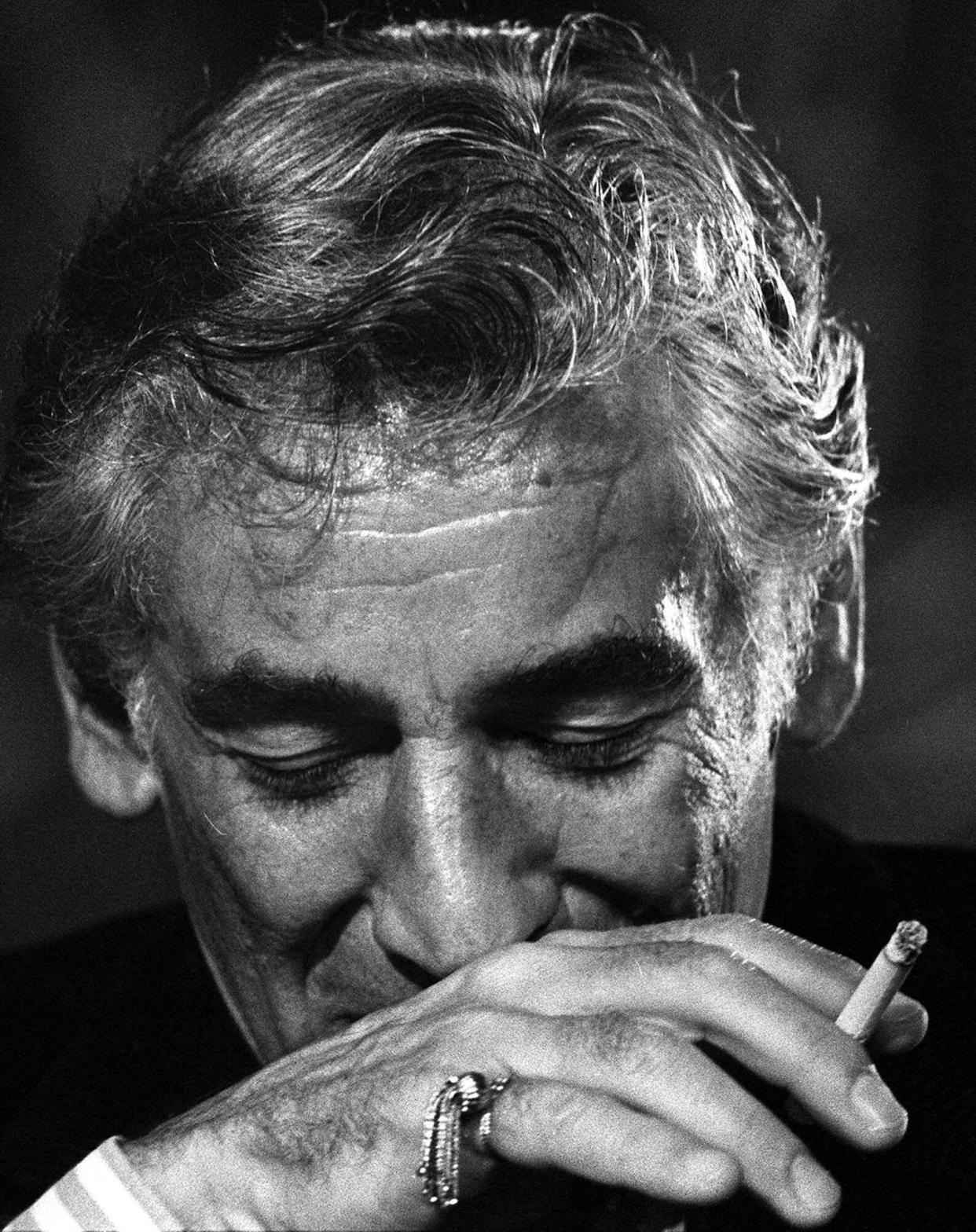 With his ever-present cigarette in hand, Leonard Bernstein pauses during a news conference in Washington on July 26, 1971.