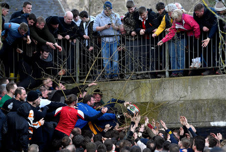 Players fight for the ball during the annual Shrovetide football match in Ashbourne, Britain March 5, 2019. REUTERS/Toby Melville