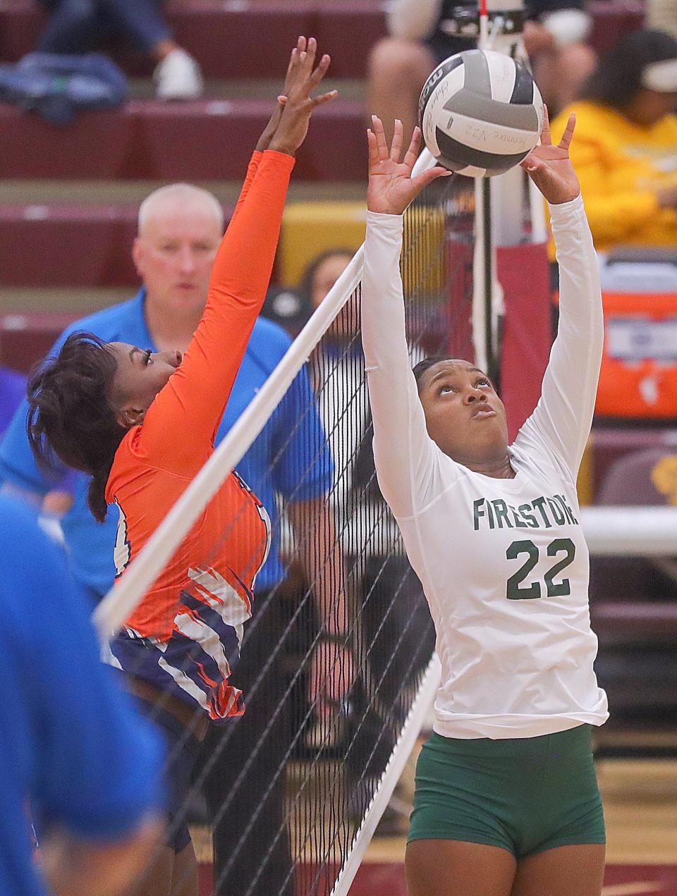 Firestone's Akia Burton sets the ball at the net against Ellet in the City Series volleyball championship on Thursday, Oct. 13, 2022 in Akron, Ohio, at Garfield High School.