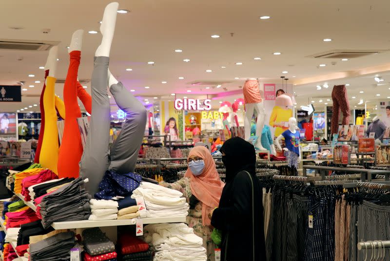 FILE PHOTO: People shop for clothes inside the Big Bazaar retail store in Mumbai