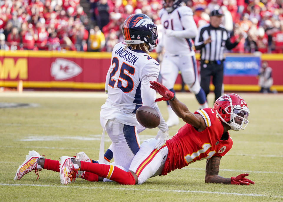 Jan 1, 2023; Kansas City, Missouri, USA; Kansas City Chiefs wide receiver Marquez Valdes-Scantling (11) celebrates by dropping the ball after being tackled by <a class="link " href="https://sports.yahoo.com/nfl/teams/denver/" data-i13n="sec:content-canvas;subsec:anchor_text;elm:context_link" data-ylk="slk:Denver Broncos;sec:content-canvas;subsec:anchor_text;elm:context_link;itc:0">Denver Broncos</a> cornerback Lamar Jackson (25) during the second half at GEHA Field at Arrowhead Stadium. Mandatory Credit: Denny Medley-USA TODAY Sports
