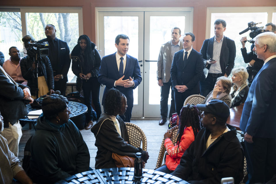 Democratic presidential candidate and former South Bend, Ind. Mayor Pete Buttigieg, center left, meets with people at the Buffalo Cafe, Sunday, March 1, 2020, in Plains, Ga. (AP Photo/Matt Rourke)