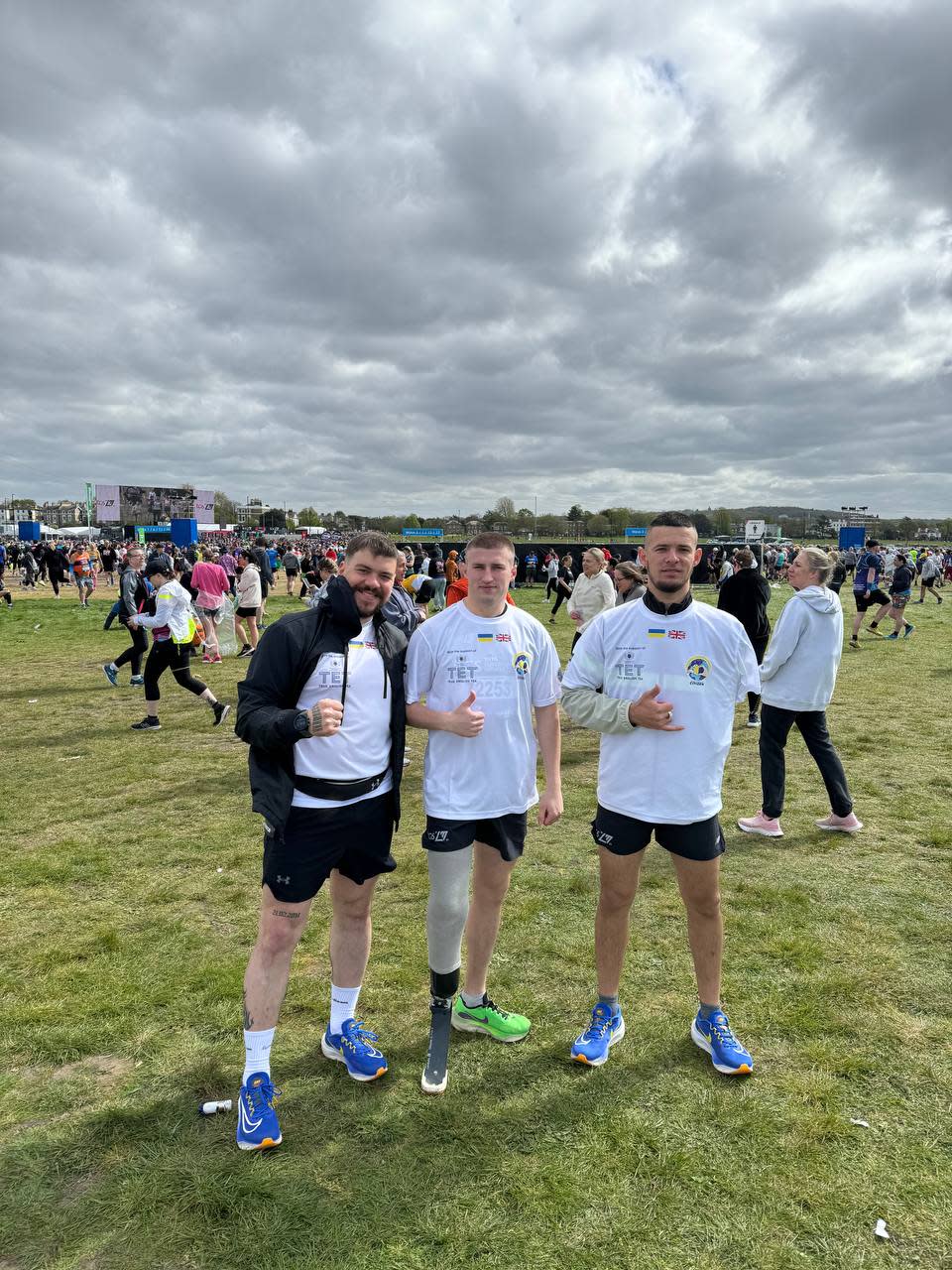 The men at the London Marathon standing on a field 