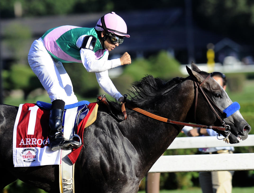 FILE - In this Aug. 27, 2016, file photo, jockey Mike Smith celebrates aboard Arrogate after winning the Travers Stakes horse race at Saratoga Race Course in Saratoga Springs, N.Y. Arrogate, winner of the 2016 Breeders’ Cup Classic and the champion 3-year-old male that year on his way to becoming North America’s all-time leading money earner, has died. He was seven. Juddmonte Farms said Arrogate was euthanized Tuesday, June 2, 2020, after becoming ill.(AP Photo/Hans Pennink, File)