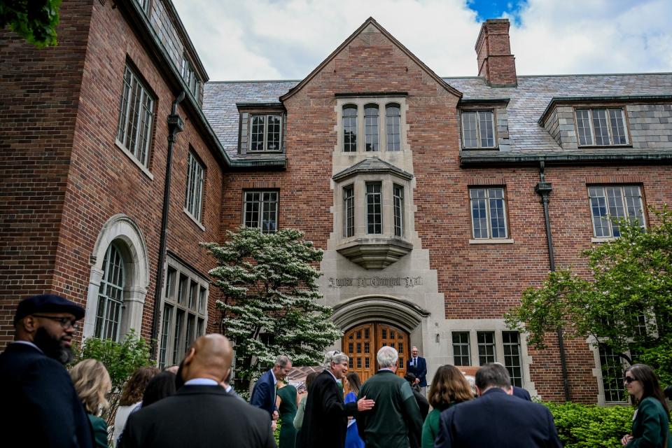 Guests mingle outside Michigan State University's Campbell Hall for a ceremony marking the beginning of renovations to the hall on Friday, May 10, 2024, in East Lansing.