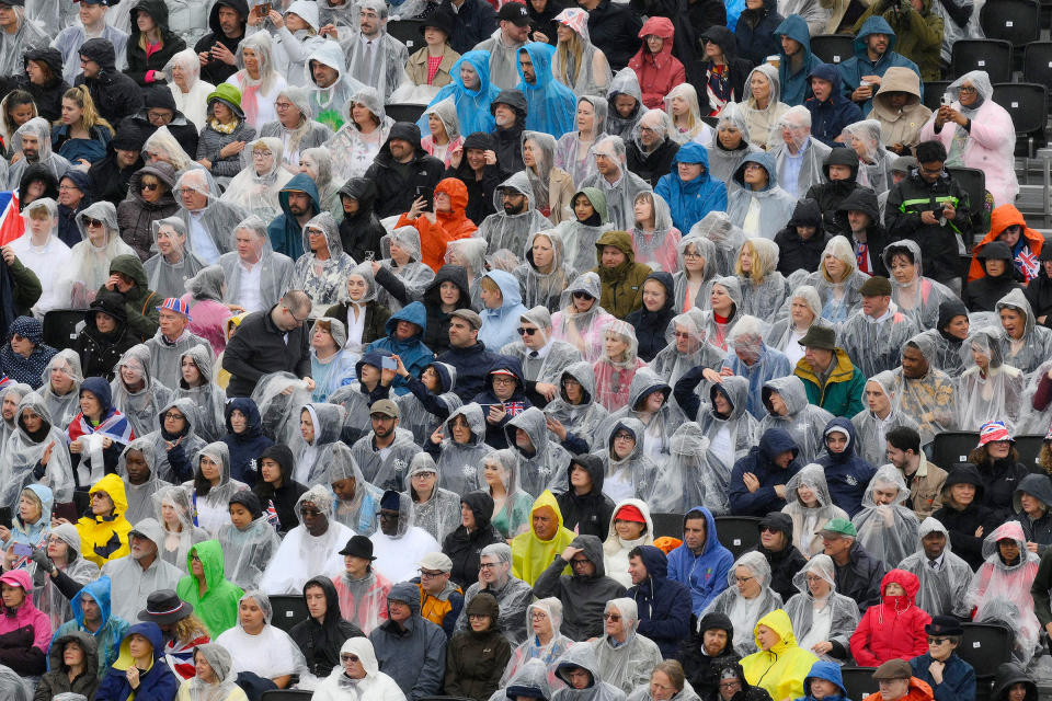 Crowds watch as the procession makes its way along the Mall during the Coronation of King Charles III and Queen Camilla.<span class="copyright">Bruce Adams—WPA Pool/Getty Images</span>