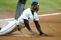 Miami Marlins' Jazz Chisholm Jr. scores on a sacrifice fly hit by Jesus Aguilar during the first inning of a baseball game against the Washington Nationals, Wednesday, May 18, 2022, in Miami. (AP Photo/Lynne Sladky)