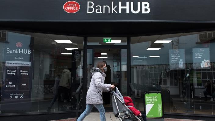 A woman pushes a baby carriage past the new Bank Hub on April 7, 2021 in Rochford, England.